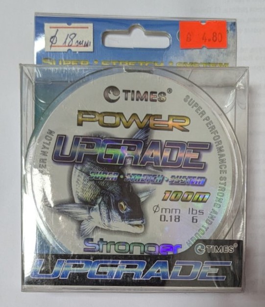 Риболовно влакно TIMES POWER UPGRADE 100 м – диаметър 0.18 мм, здравина 6 lbs, в прозрачна опаковка с холограмен етикет и изображение на риба.